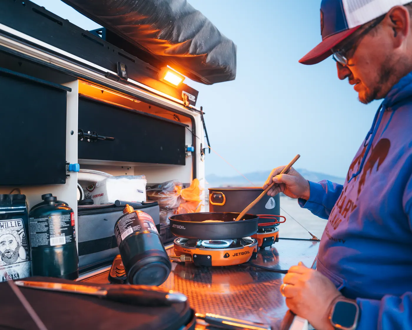 Cooking at a slide-out camp kitchen at dusk